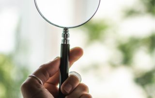 tilt-shift-lens-photography-of-person-holding-magnifying-1192333